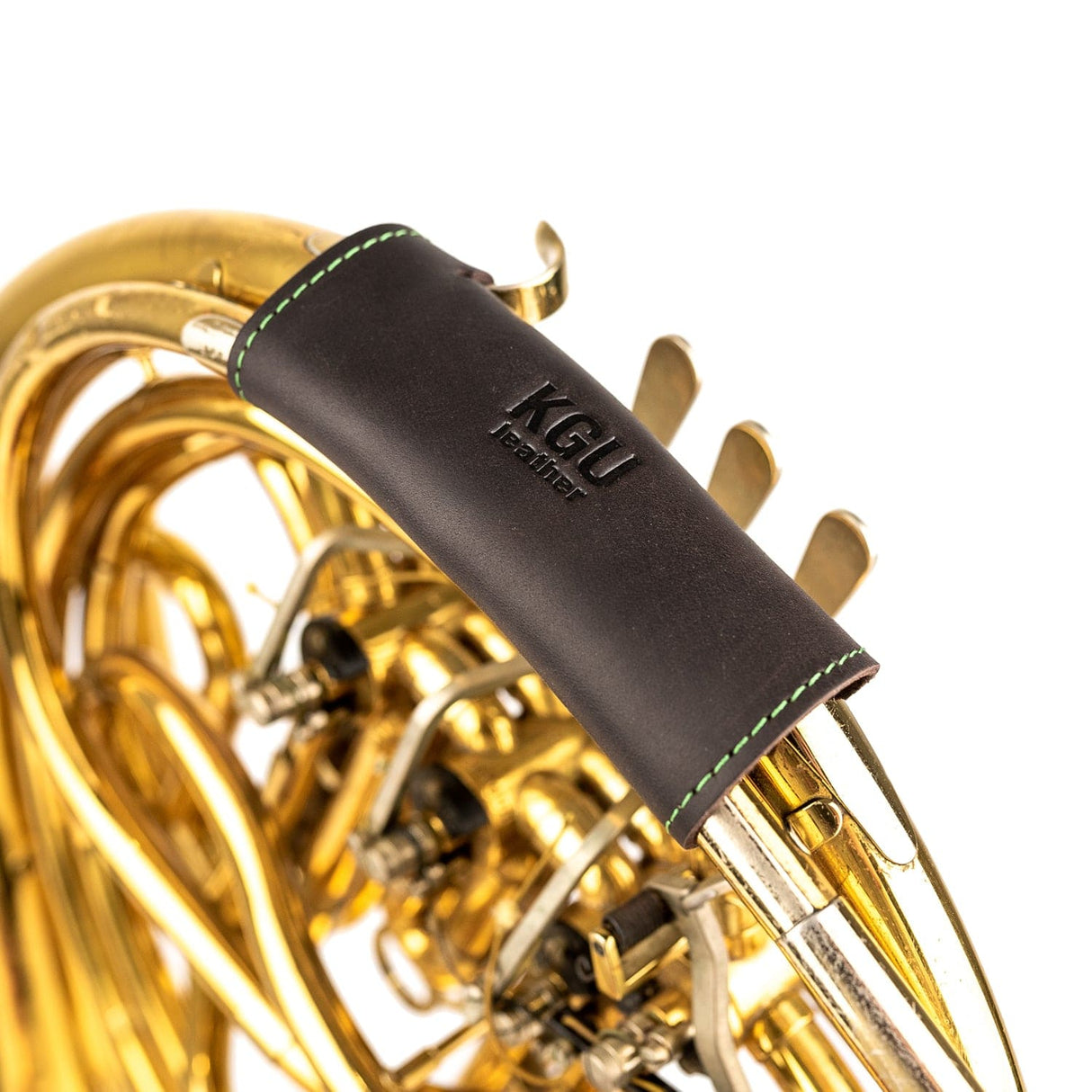 Top-down view of KGUmusic single French horn leather hand guard on white.