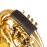 Top-down view of KGUmusic single French horn leather hand guard on white.