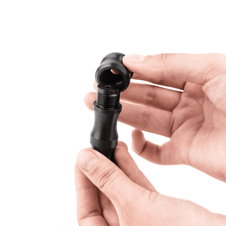 Trumpet BuzzMaster by KGUmusic held in hands, adjustable for resistance.