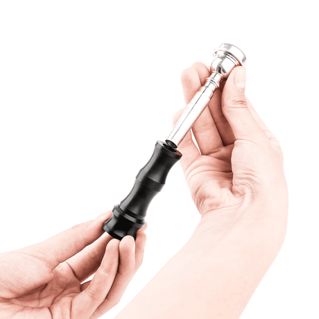 BuzzMaster tool for trumpet practice is inserted into the mouthpiece.