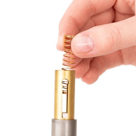Close-up of KGUmusic bronze trumpet valve spring.
