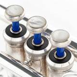Detail shot of one KGUmusic brass Blue Lacquer valve stem on a trumpet.