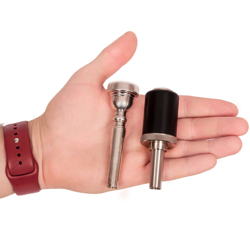 KGUmusic trumpet pressure optimizer and mouthpiece in man's hand.