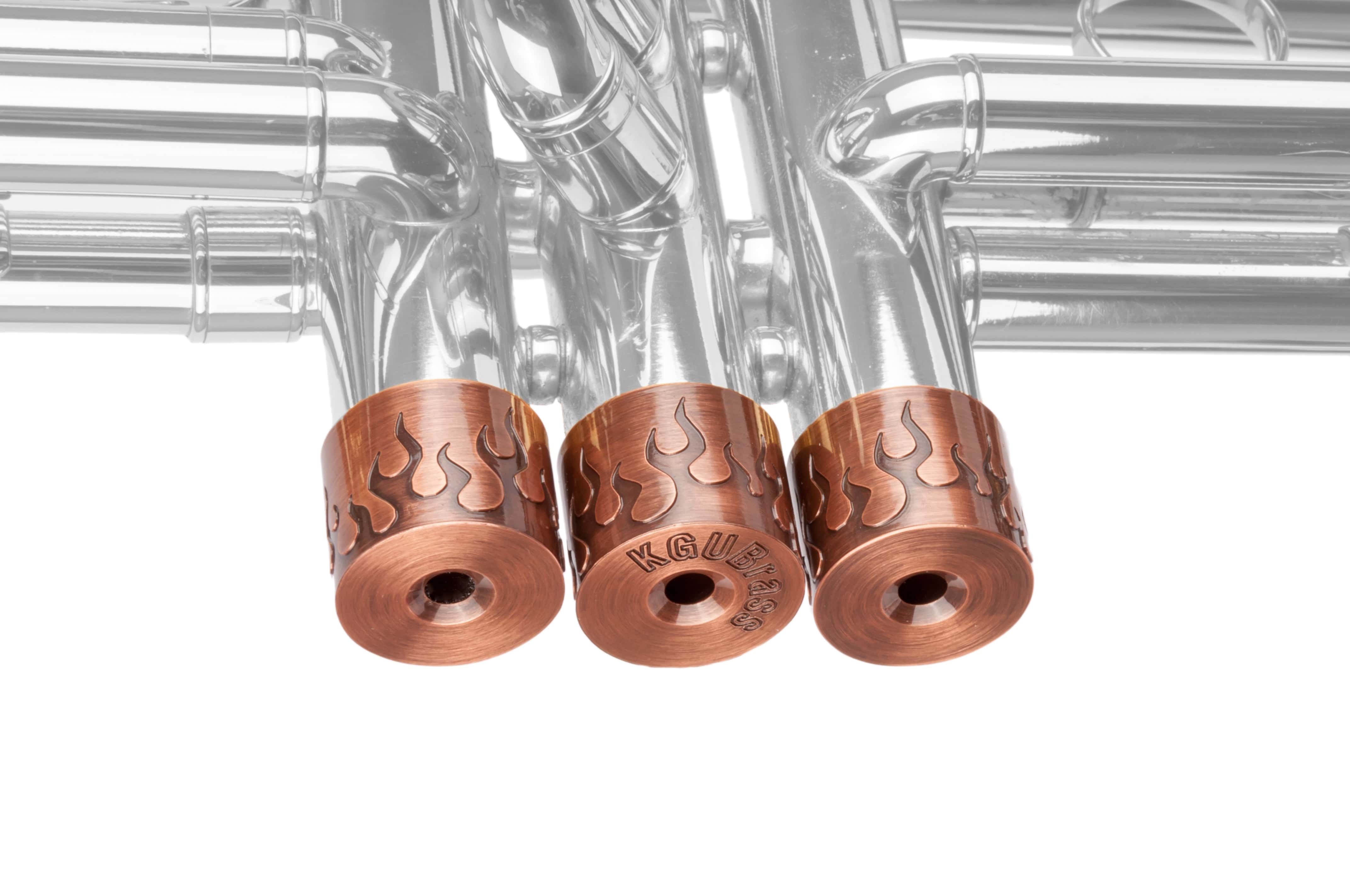 Side profile of set of 3 trumpet valve caps with flamer engraving on a trumpet.