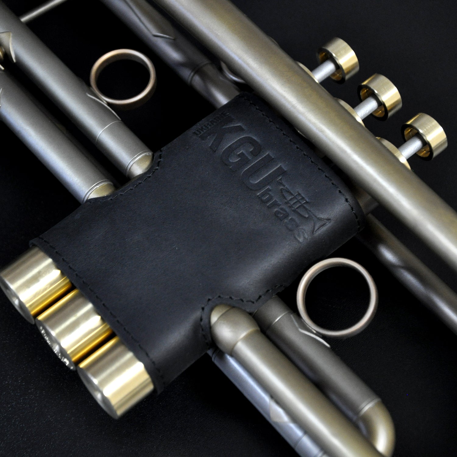 Genuine leather valve guards from KGUmusic in black colors, on trumpet.